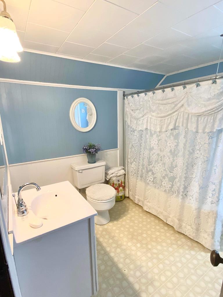 1007 Perryville Road Parker, PA 16049 - Photo 14 of 20 a bathroom with a sink mirror vanity and toilet