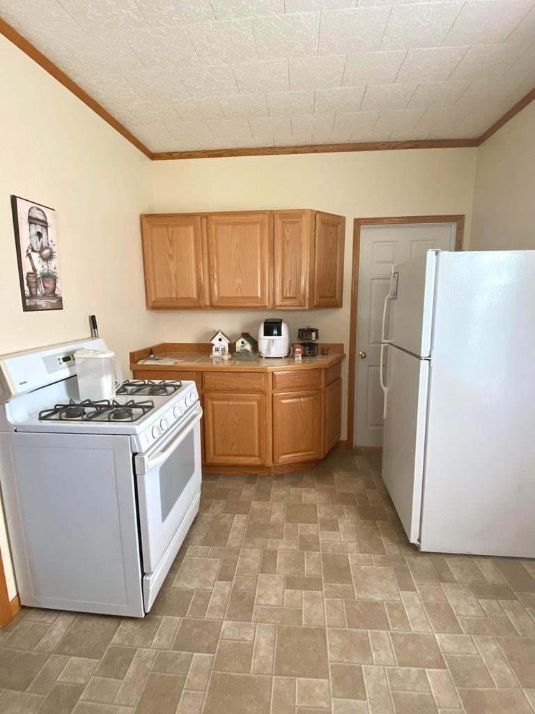 1007 Perryville Road Parker, PA 16049 - Photo 19 of 20 a kitchen with a stove a refrigerator and a sink