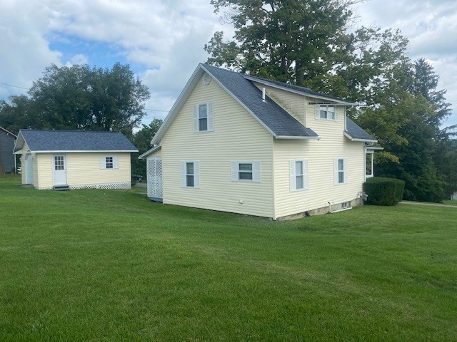 1007 Perryville Road Parker, PA 16049 - Photo 3 of 20 a view of a white house in front of a yard with plants and large trees