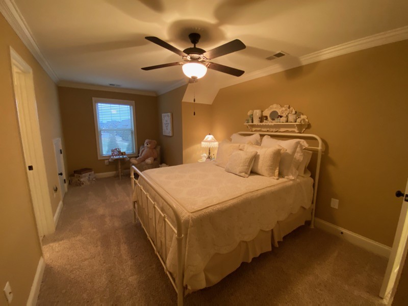 445 Huntington Drive Lebanon, TN 37087 - Photo 38 of 50 a spacious bedroom with a bed and a chandelier