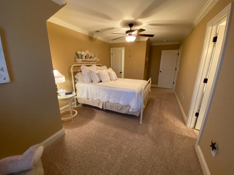 445 Huntington Drive Lebanon, TN 37087 - Photo 39 of 50 a spacious bedroom with a bed and a chandelier