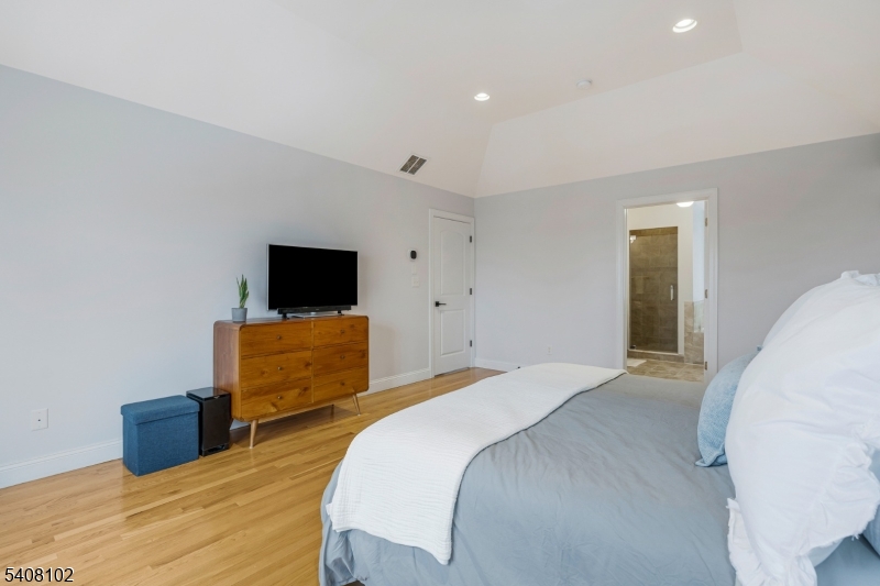 5 Ridge Road Warren, NJ 07059 - Photo 20 of 39 a bedroom with a bed and flat screen tv