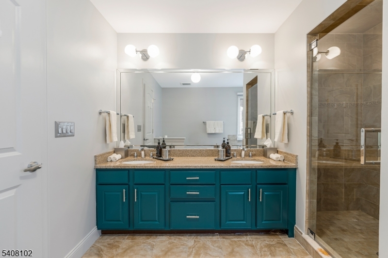 5 Ridge Road Warren, NJ 07059 - Photo 21 of 39 a bathroom with a double vanity sink and a mirror
