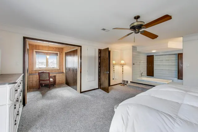 a bedroom with furniture and a ceiling fan