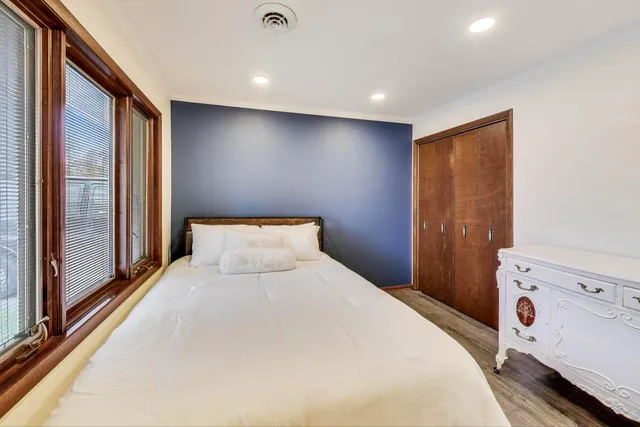 a bedroom with a large bed and a large window