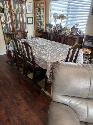 a view of a dining room with furniture and chandelier