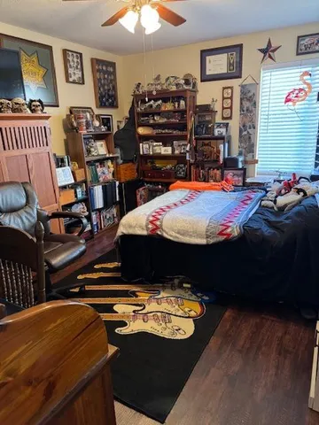 a bed sitting in a bedroom next to a lamp