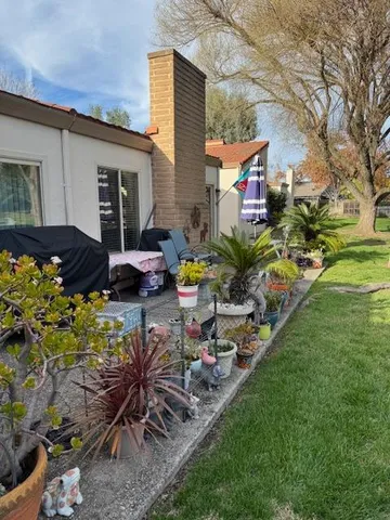 a backyard of a house with table and chairs