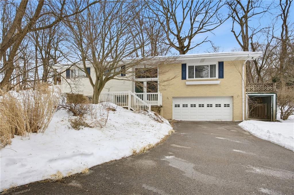 a view of a house with a snow in the yard