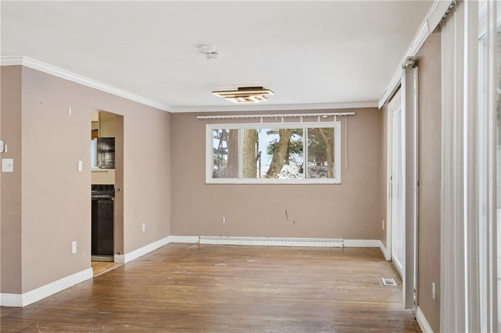 3801 Greenfield Road Allison Park, PA 15101 - Photo 14 of 39 an empty room with wooden floor ceiling fan and windows