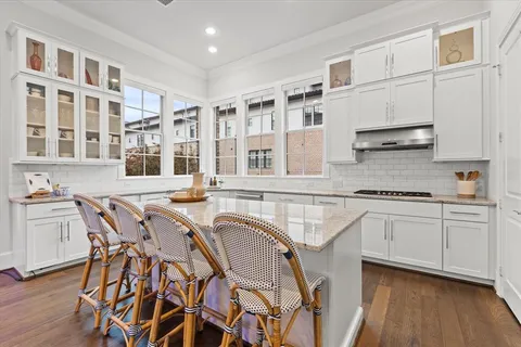 a kitchen with stainless steel appliances granite countertop a stove a sink dishwasher and cabinets with wooden floor