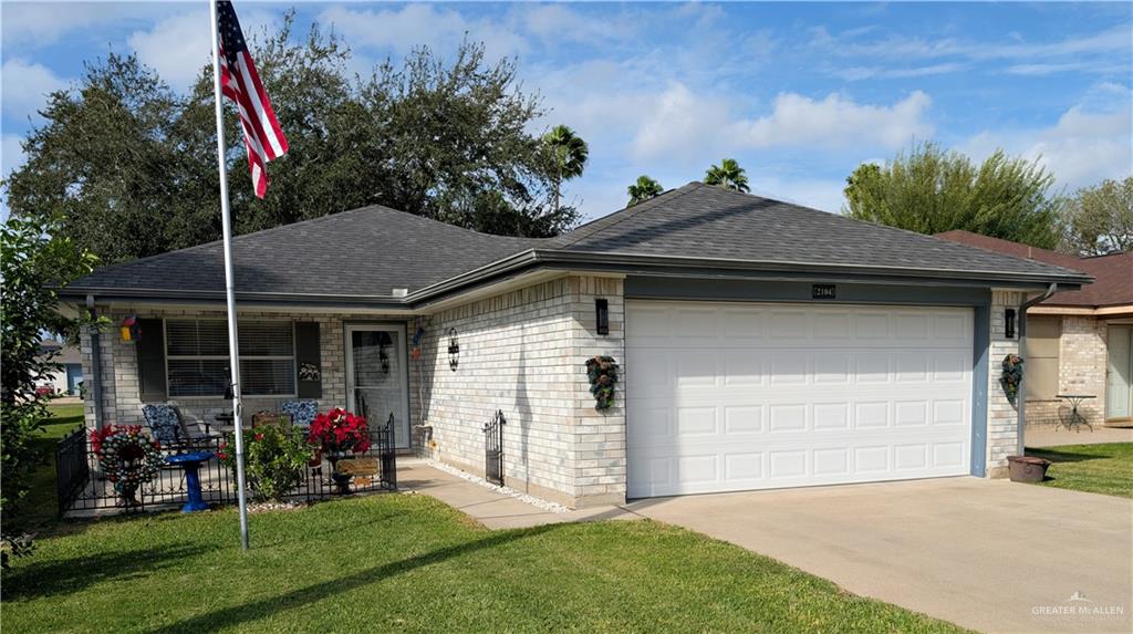 a view of a house with backyard and porch