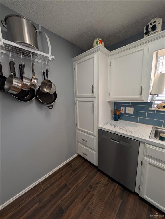 2104 Mockingbird Street Palmview, TX 78572 - Photo 12 of 23 a kitchen with cabinets a sink and wooden floor
