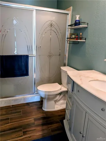 a bathroom with a toilet and a shower