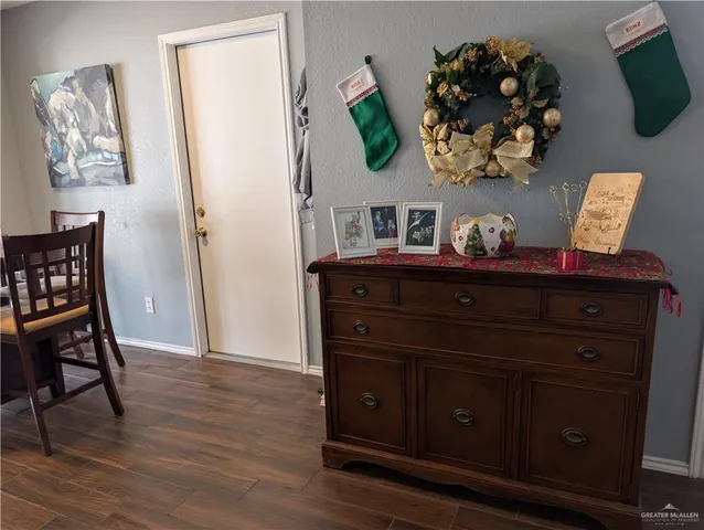 a view of a dining room with furniture and wooden floor
