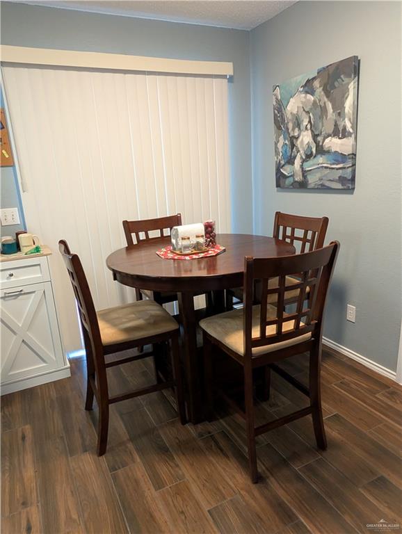2104 Mockingbird Street Palmview, TX 78572 - Photo 10 of 23 a view of a dining room with furniture and wooden floor