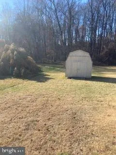a view of pool with a yard