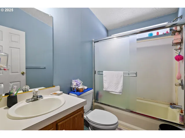 a bathroom with a sink toilet and a mirror