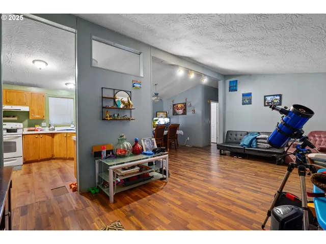 a living room with furniture gym equipment and a flat screen tv