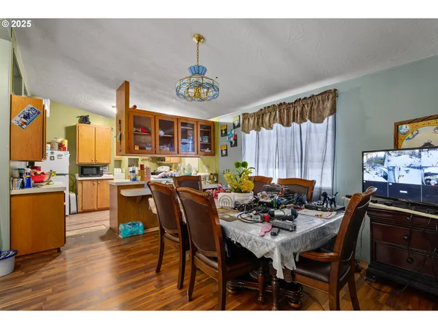 a view of a dining room with furniture and chandelier