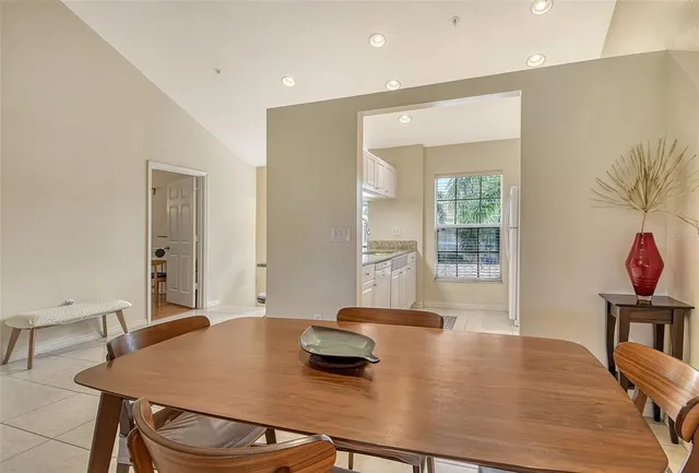 a kitchen with granite countertop a refrigerator and a sink