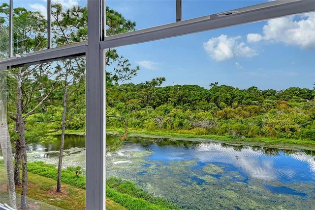 a view of a lake with houses in the back