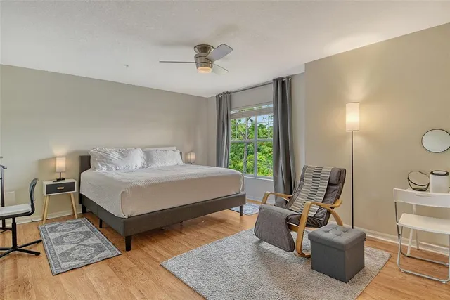 a living room with stainless steel appliances furniture a dining table and kitchen view