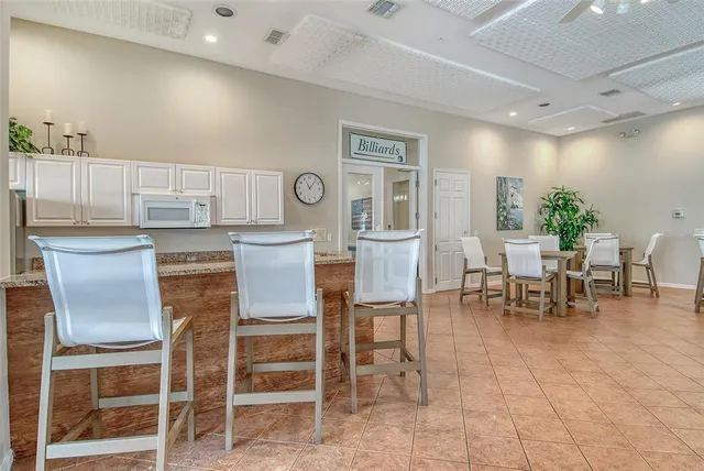 a view of swimming pool with a yard and palm trees