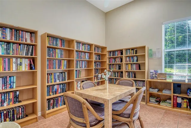 a front view of a house with garden and trees