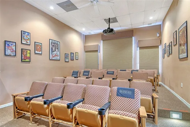 a view of a white house sitting in a big yard with large trees