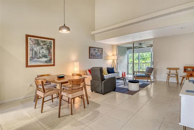 a bedroom with a bed and large windows