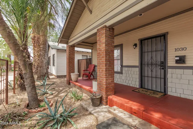 a view of a house with backyard porch and sitting area
