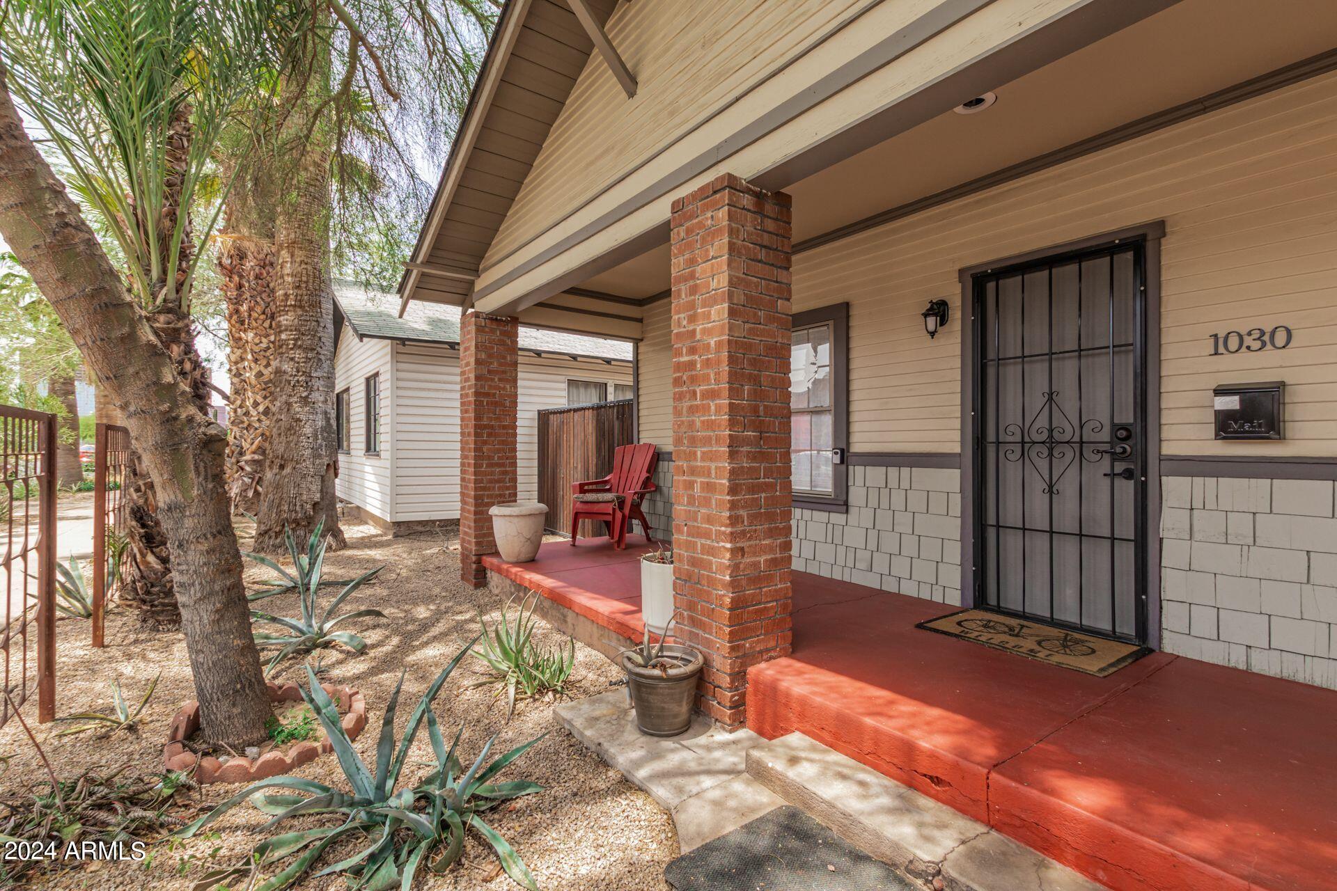 a view of a house with backyard porch and sitting area