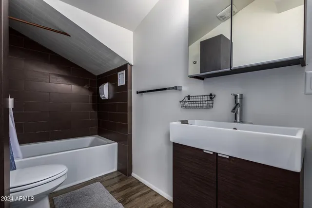 a bathroom with a sink a toilet and bathtub