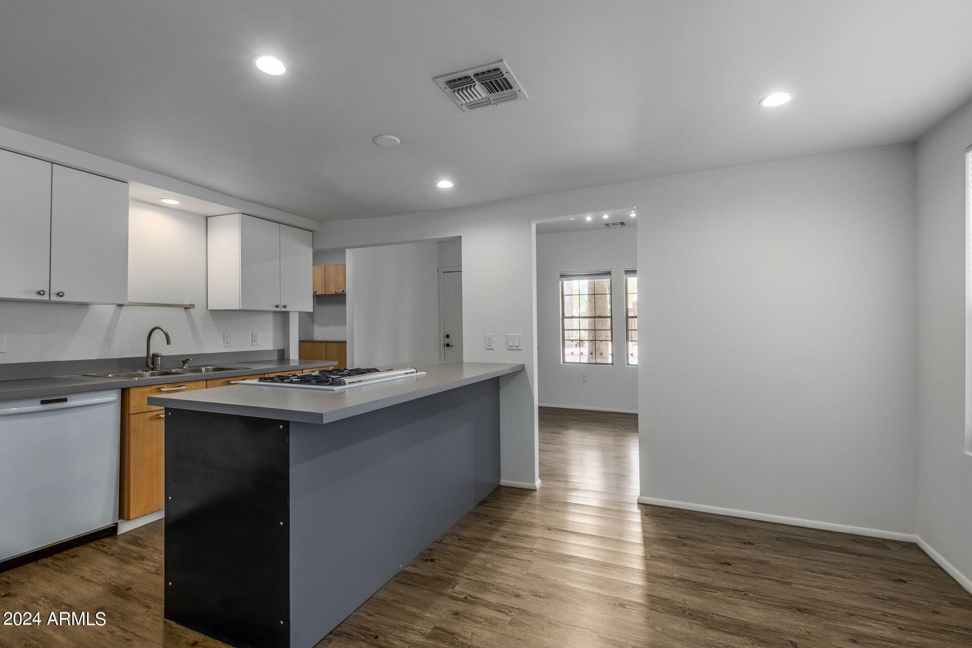 1030 East Polk Street Phoenix, AZ 85006 - Photo 10 of 33 a kitchen with counter top space and wooden floor