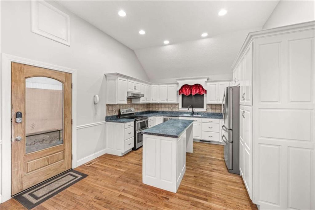 131 Caudell Drive Lula, GA 30554 - Photo 22 of 58 a kitchen view with stainless steel appliances kitchen island granite countertop a refrigerator and a sink