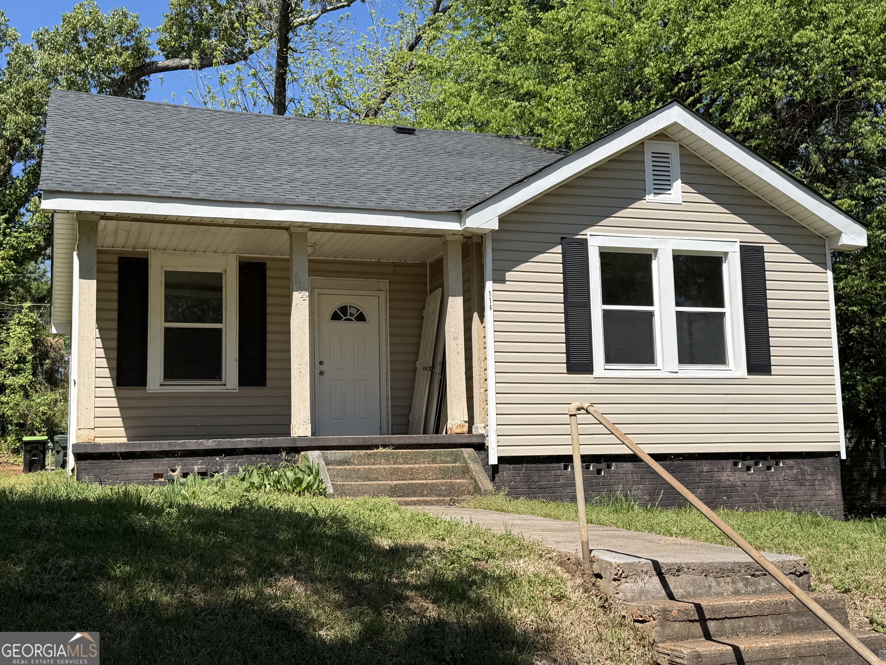 a front view of a house with garden