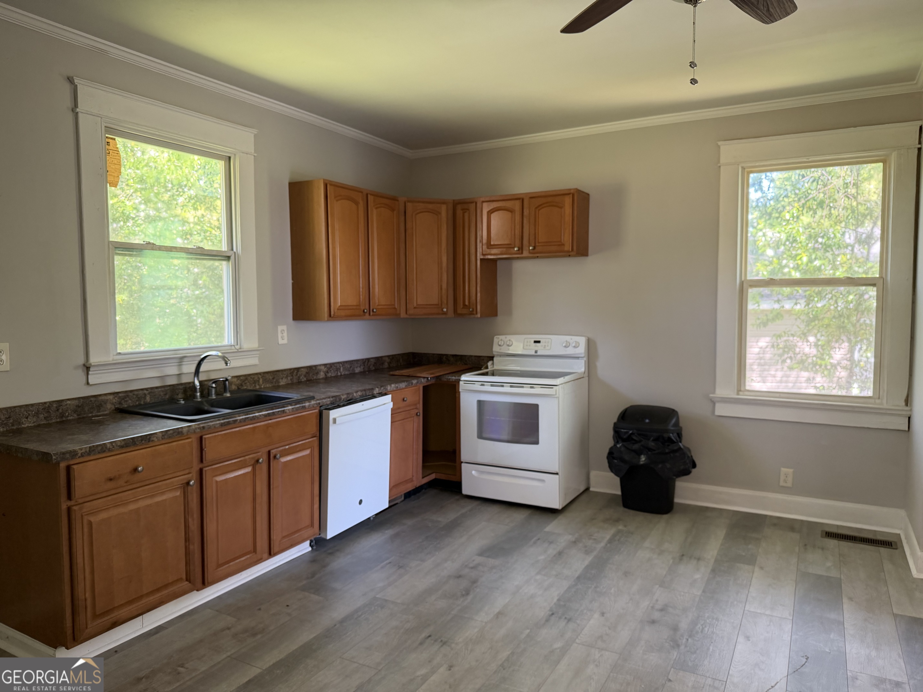 114 A Street Northeast Thomaston, GA 30286 - Photo 2 of 11 a kitchen with granite countertop a stove a sink and a microwave