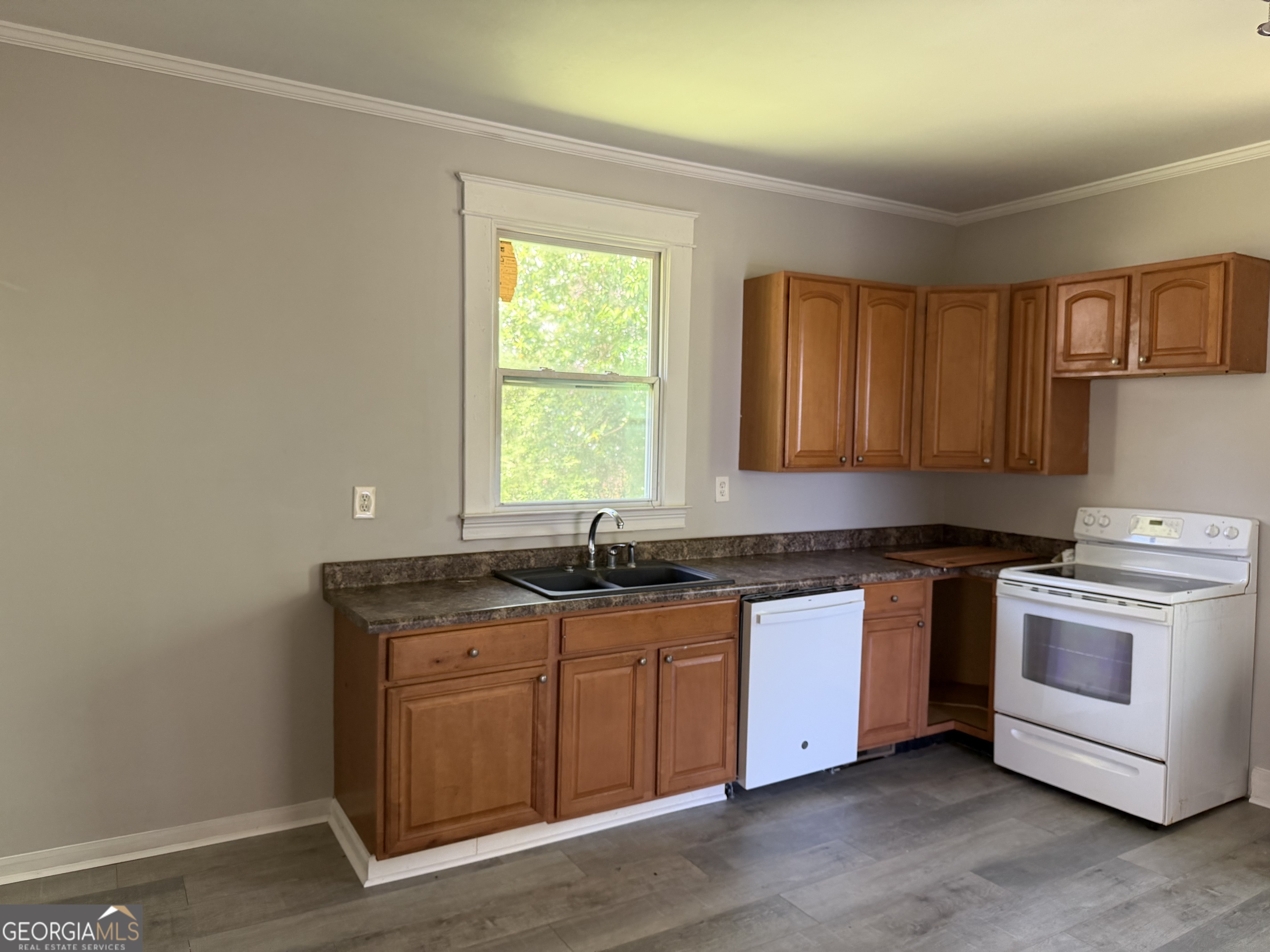 114 A Street Northeast Thomaston, GA 30286 - Photo 3 of 11 a kitchen with stainless steel appliances granite countertop a stove a sink and a microwave