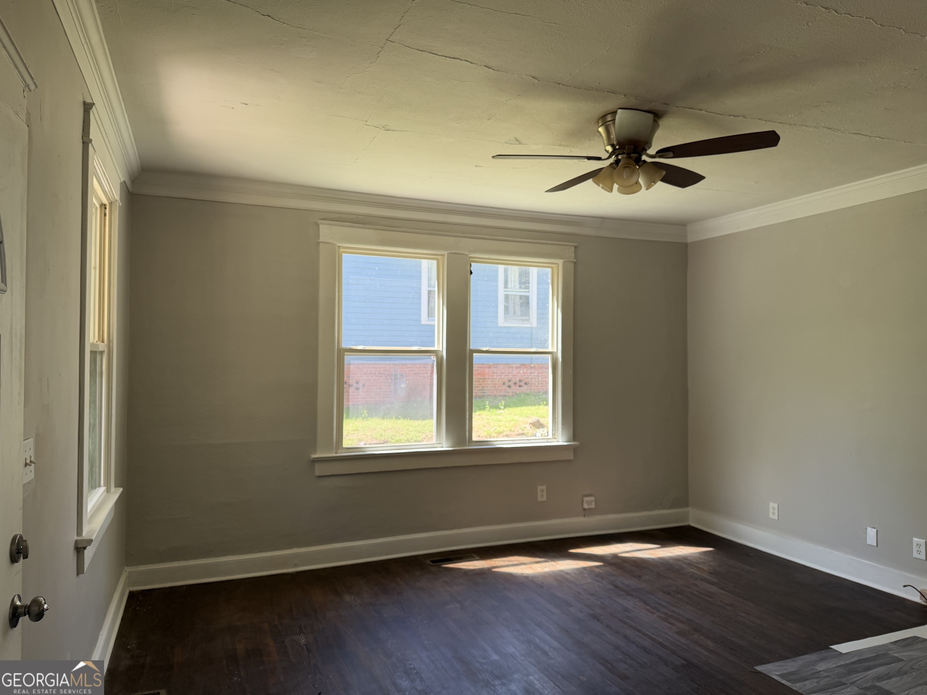 114 A Street Northeast Thomaston, GA 30286 - Photo 7 of 11 an empty room with wooden floor fan and windows