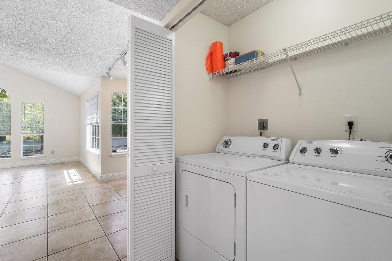 1275 Crystal Way, Unit B Delray Beach, FL 33444 - Photo 13 of 37 a view of storage and utility room with washer and dryer