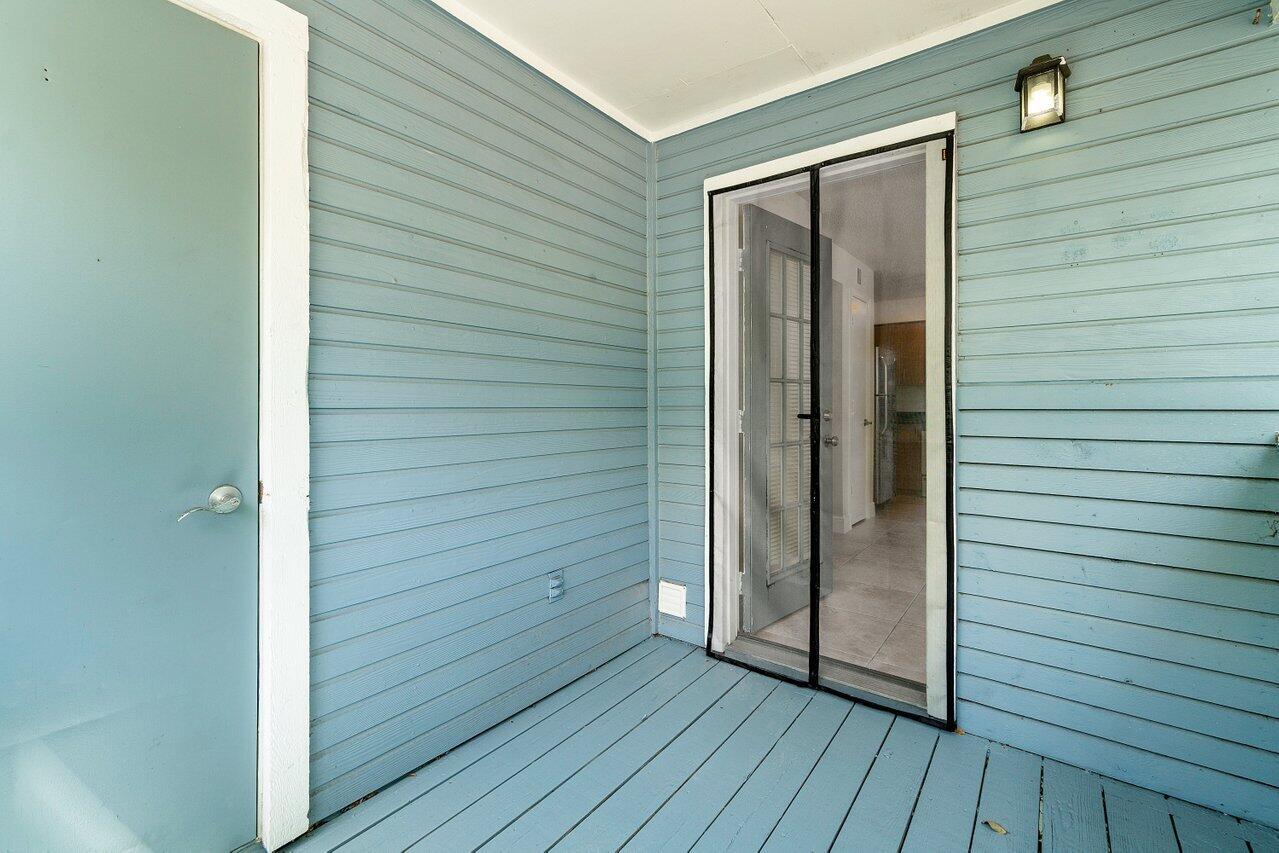 1275 Crystal Way, Unit B Delray Beach, FL 33444 - Photo 15 of 37 a view of front door and wooden deck