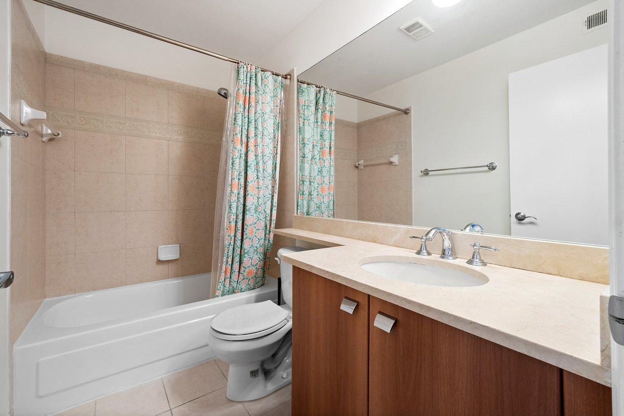 1275 Crystal Way, Unit B Delray Beach, FL 33444 - Photo 18 of 37 a bathroom with a sink a toilet and shower