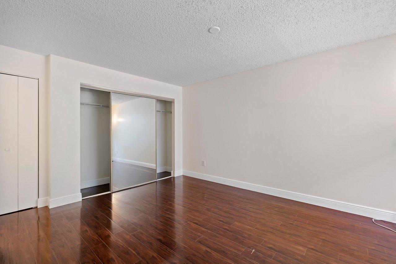 1275 Crystal Way, Unit B Delray Beach, FL 33444 - Photo 22 of 37 a view of an empty room with wooden floor