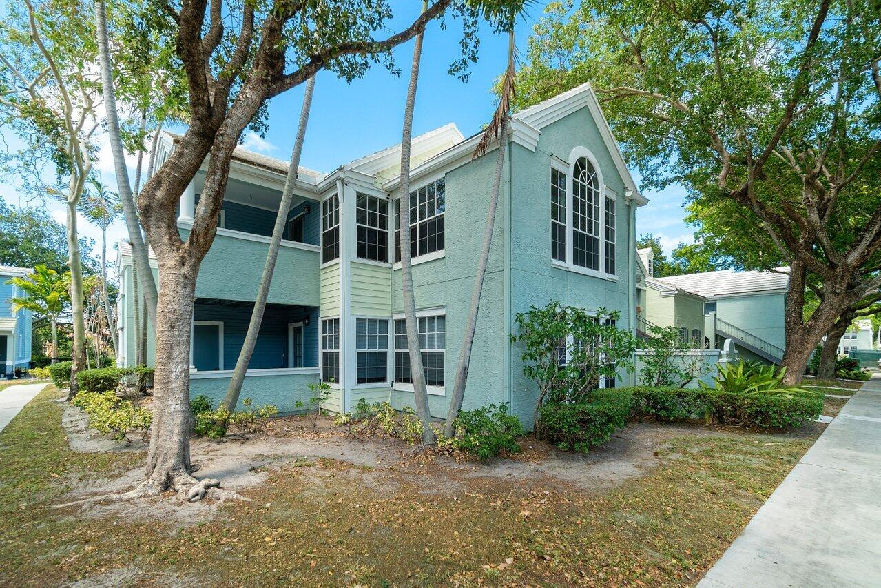 1275 Crystal Way, Unit B Delray Beach, FL 33444 - Photo 25 of 37 a front view of a house with garden