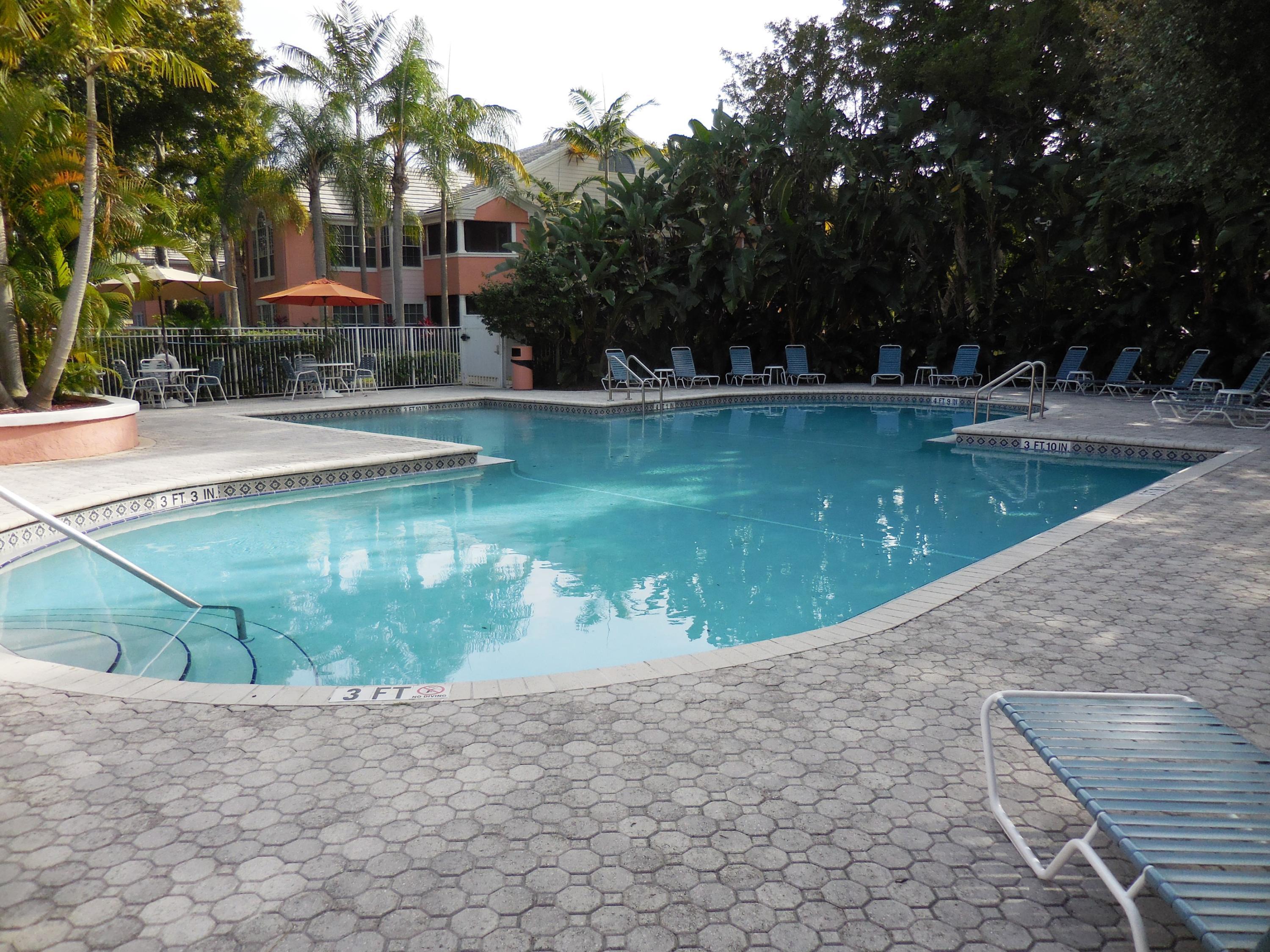 1275 Crystal Way, Unit B Delray Beach, FL 33444 - Photo 27 of 37 a view of a swimming pool with a patio