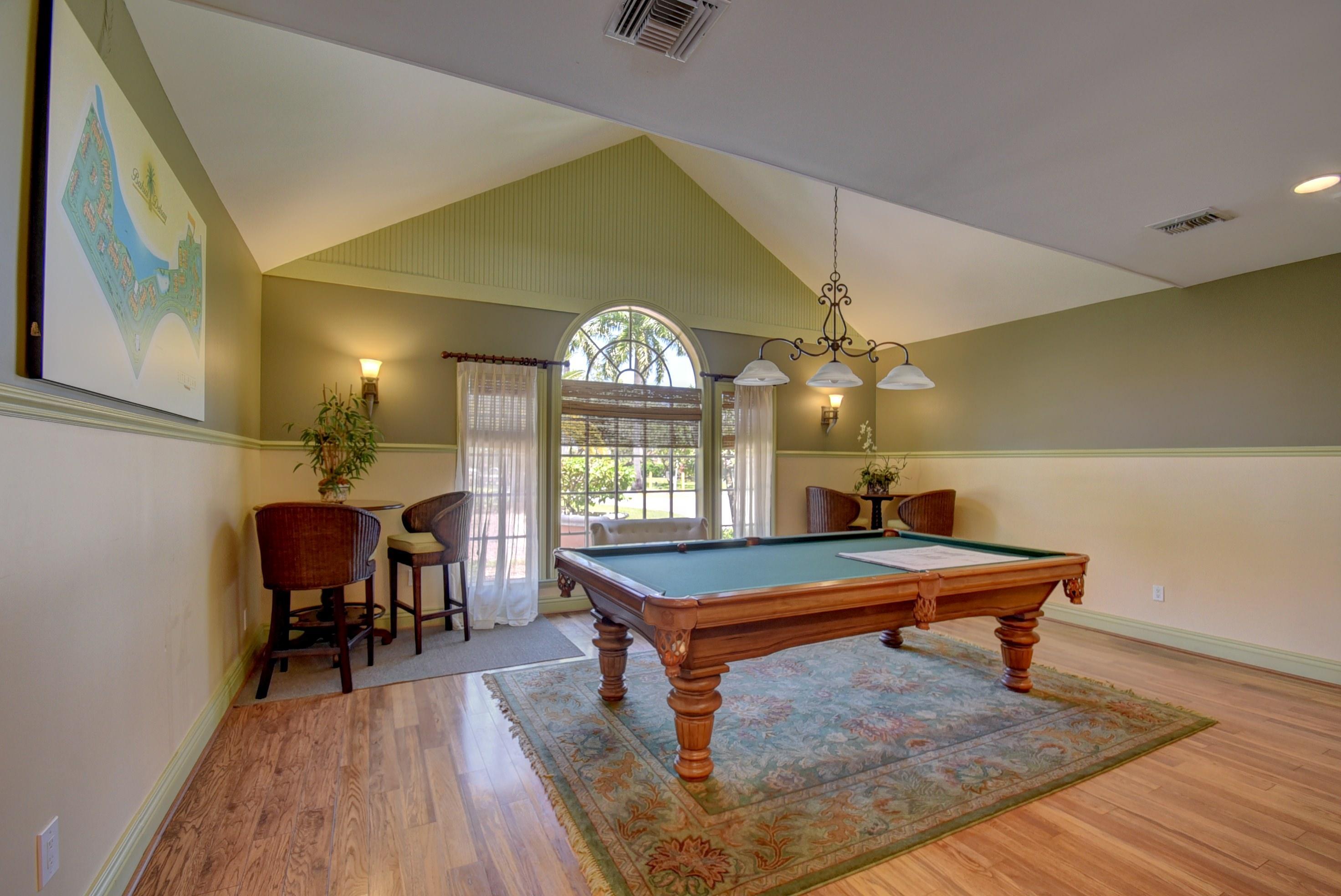 1275 Crystal Way, Unit B Delray Beach, FL 33444 - Photo 35 of 37 a room with wooden floor pool table and windows