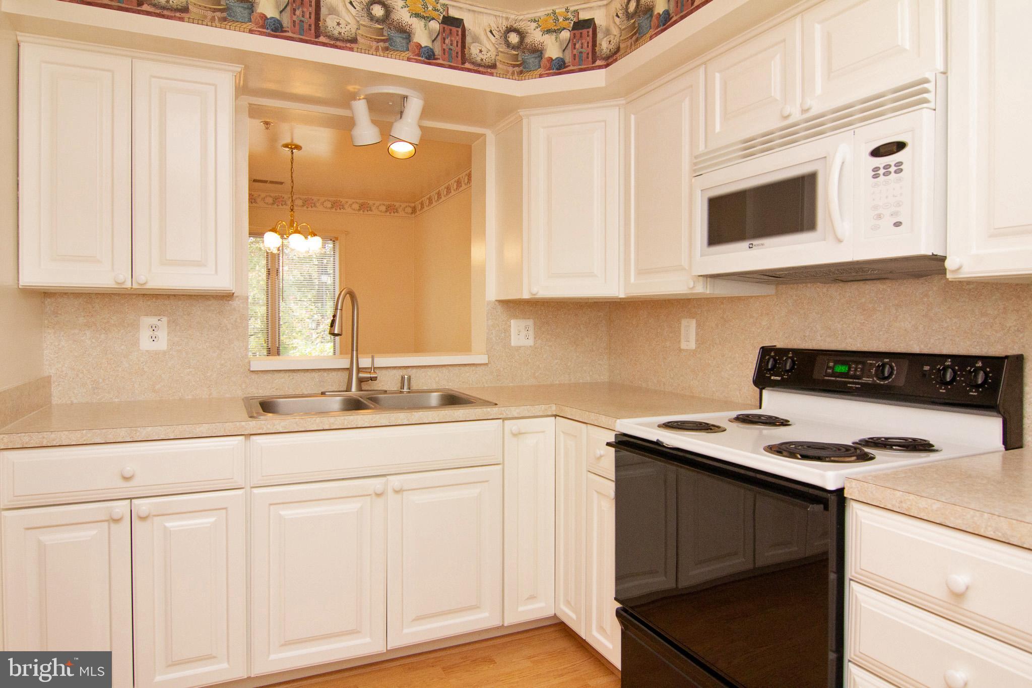 425 Pleasanton Road, Unit C14 Westminster, MD 21157 - Photo 10 of 28 Kitchen has a lot of cabinets & pass thru window