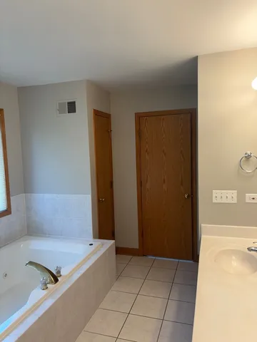 a bathroom with a tub and shower