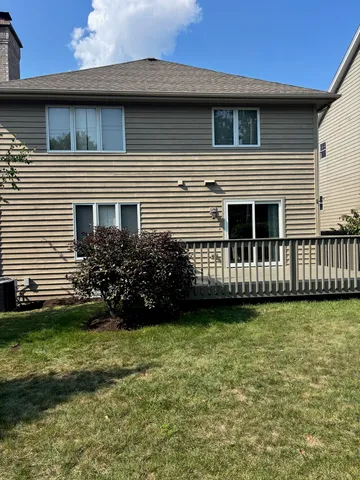 a view of a house with backyard and garden